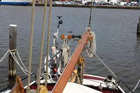 Sailing boat Zeeschouw Liamer (Bekebrede) 1987 moored at a dock with ropes and mast.