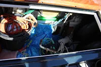 Storage compartment of 1987 Zeeschouw Liamer boat with ropes and equipment.