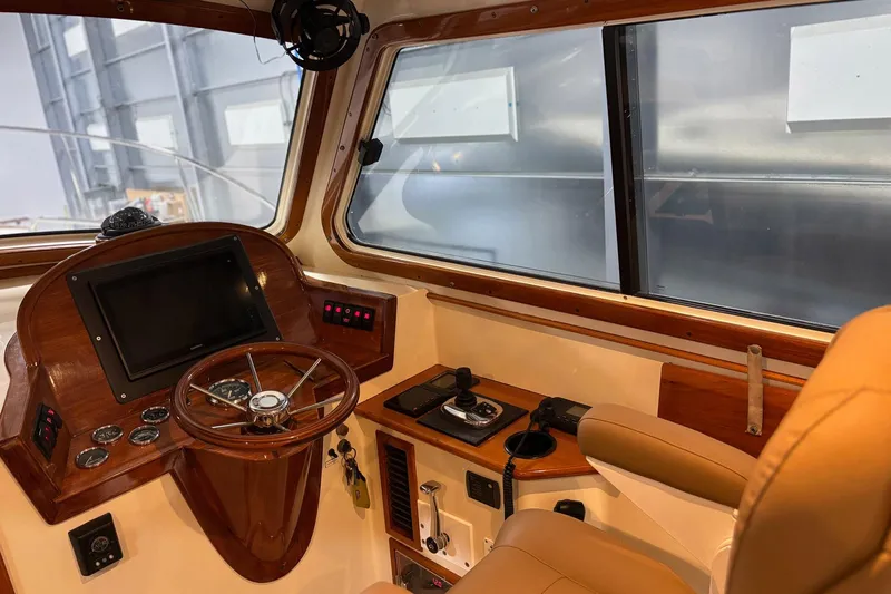 Pirouette Yacht Photos Pics 2003 Hinckley 36 Picnic Boat EP interior helm with wooden dashboard and leather seating.