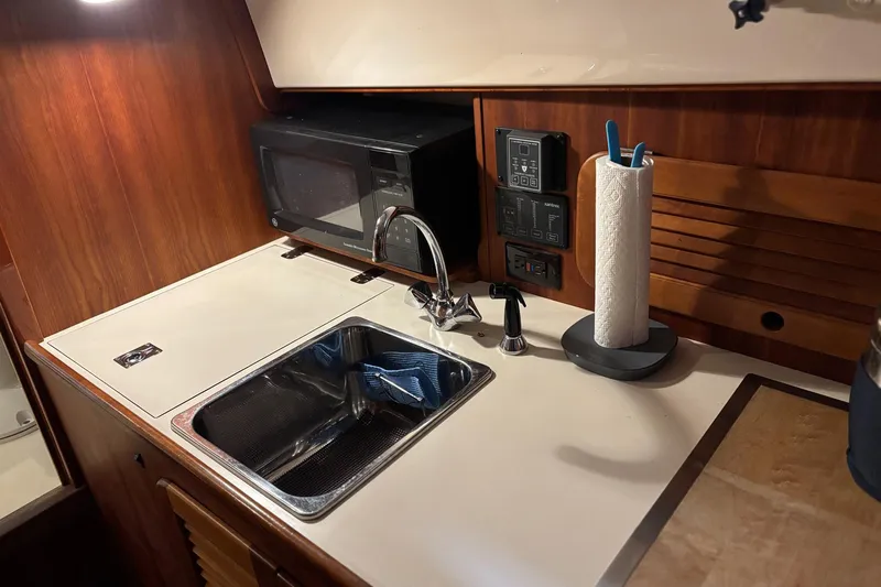 Pirouette Yacht Photos Pics 2003 Hinckley 36 Picnic Boat EP galley with sink, microwave, and paper towel holder.