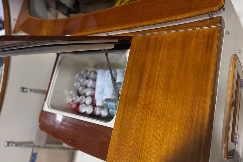 Pirouette Yacht Photos Pics Hinckley 36 Picnic Boat EP 2003 with open wooden storage compartment, revealing drinks inside.