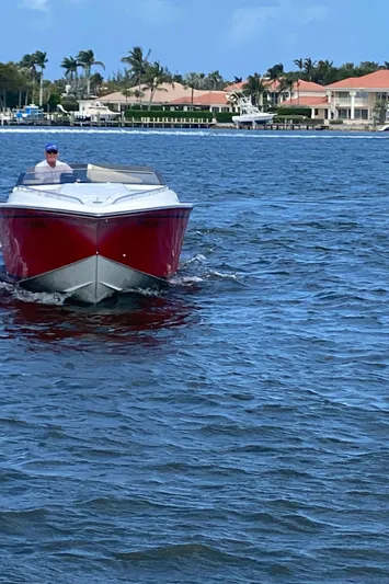 Wheeler Dealer Yacht Photos Pics 2006 Fountain 42 Executioner speedboat cruising on a sunny day near waterfront homes.