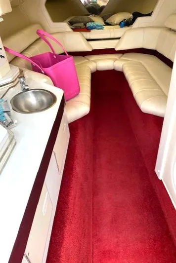 Wheeler Dealer Yacht Photos Pics Interior of 2006 Fountain 42 Executioner boat with red carpet and beige seating.