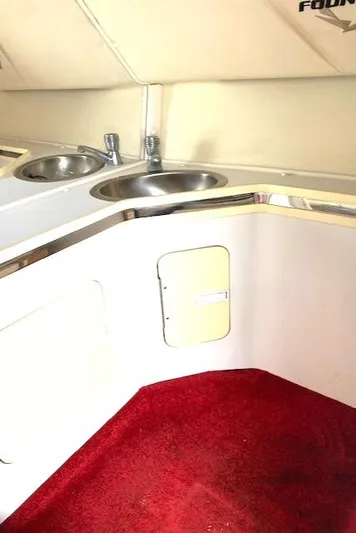 Wheeler Dealer Yacht Photos Pics Interior of 2006 Fountain 42 Executioner boat with red carpet and dual sinks.