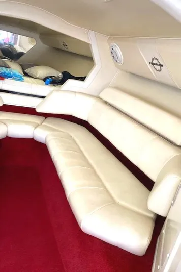 Wheeler Dealer Yacht Photos Pics 2006 Fountain 42 Executioner interior with white leather seating and red carpet.