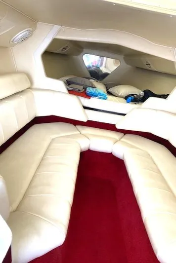 Wheeler Dealer Yacht Photos Pics 2006 Fountain 42 Executioner cabin with white leather seating and red carpet.