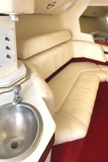 Wheeler Dealer Yacht Photos Pics 2006 Fountain 42 Executioner interior with cream leather seating and stainless steel sink.