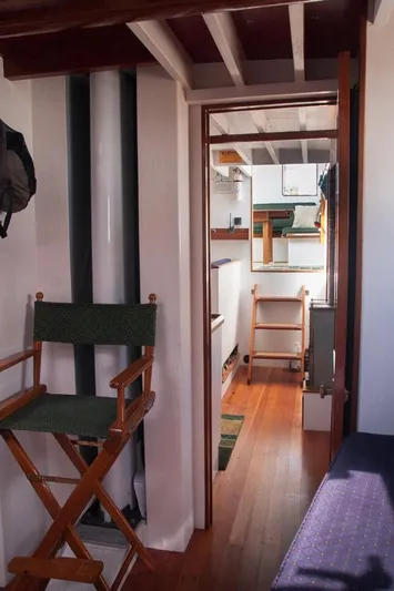 Miss Nina Yacht Photos Pics Interior of 1996 Custom Bolger PH Shoal-draft Ketch with wooden flooring and seating.