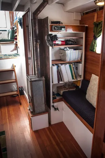 Miss Nina Yacht Photos Pics Cozy interior of 1996 Custom Bolger PH Shoal-draft Ketch with wood stove and seating area.