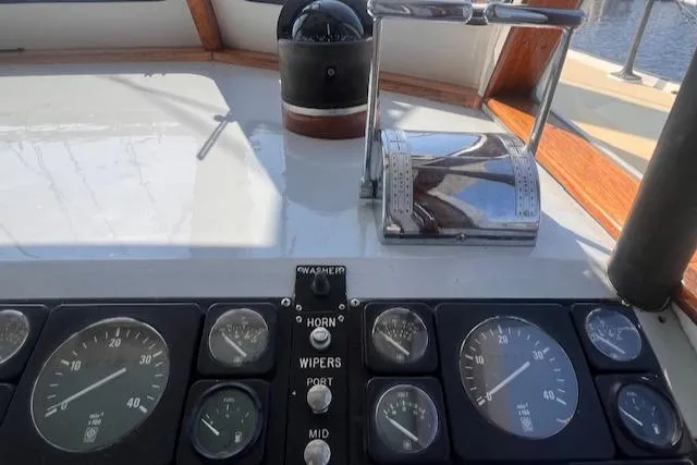 Miss Nina Yacht Photos Pics Control panel of a 1996 Custom Bolger PH Shoal-draft Ketch with gauges and throttle.