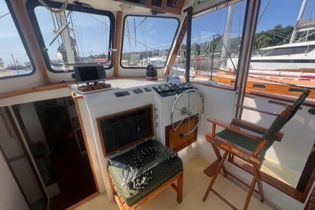 Miss Nina Yacht Photos Pics Interior of 1996 Custom Bolger PH Shoal-draft Ketch, featuring helm and navigation equipment.