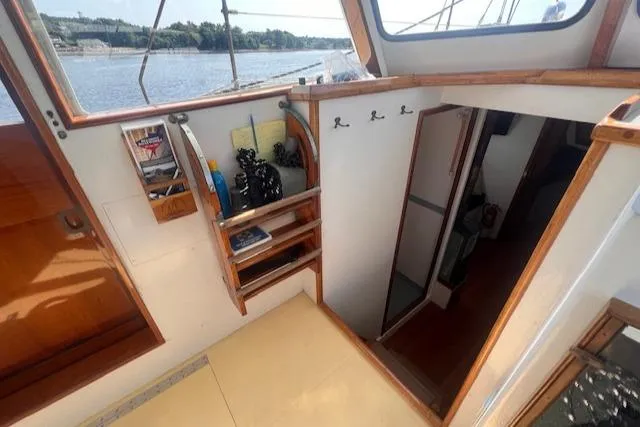Miss Nina Yacht Photos Pics Interior of 1996 Custom Bolger PH Shoal-draft Ketch with wooden accents and river view.