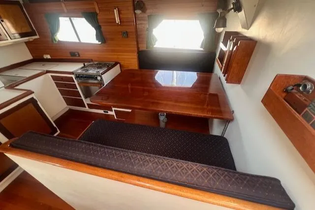 Miss Nina Yacht Photos Pics Interior of 1996 Custom Bolger PH Shoal-draft Ketch with dining area and kitchen.