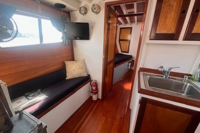 Miss Nina Yacht Photos Pics Interior of 1996 Custom Bolger PH Shoal-draft Ketch with wood finish and cozy seating.