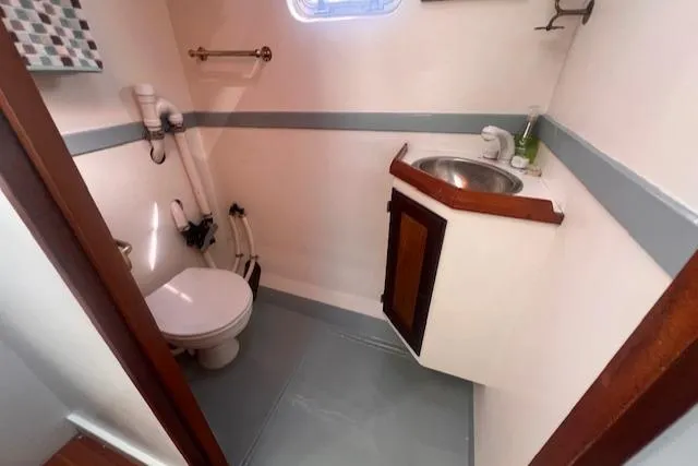 Miss Nina Yacht Photos Pics Bathroom interior of 1996 Custom Bolger PH Shoal-draft Ketch with sink and toilet.