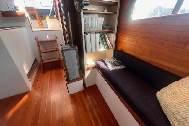 Miss Nina Yacht Photos Pics Interior of 1996 Custom Bolger PH Shoal-draft Ketch with wooden flooring and cozy seating.