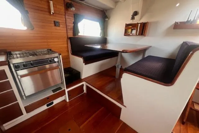 Miss Nina Yacht Photos Pics Interior of 1996 Custom Bolger PH Shoal-draft Ketch with dining area and stove.