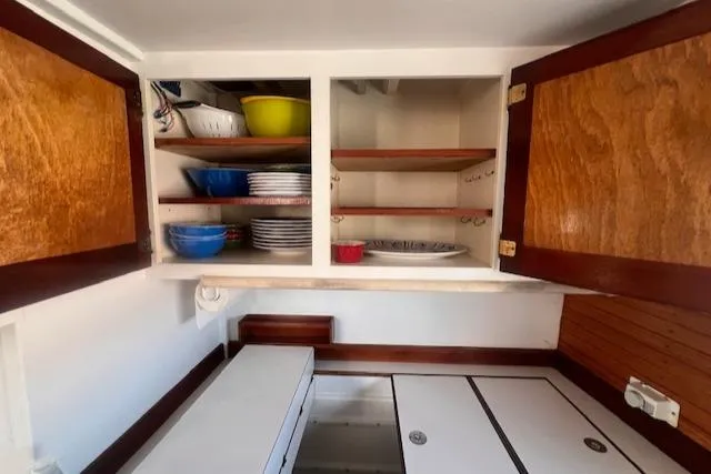 Miss Nina Yacht Photos Pics Interior of 1996 Custom Bolger PH Shoal-draft Ketch with open wooden cabinets.