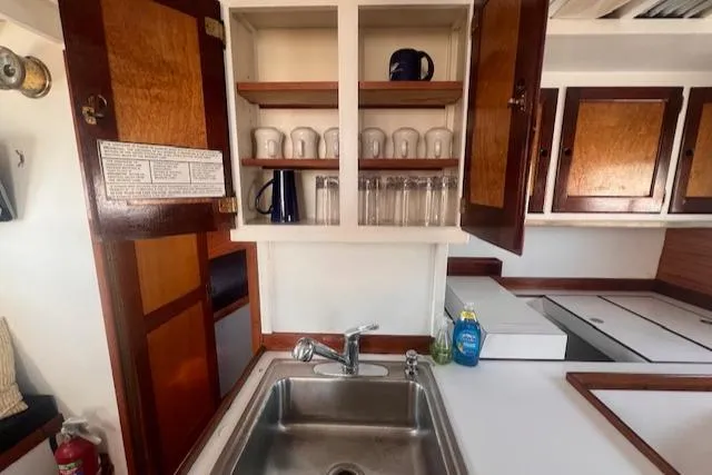 Miss Nina Yacht Photos Pics Interior of 1996 Custom Bolger PH Shoal-draft Ketch with sink and open cabinet.