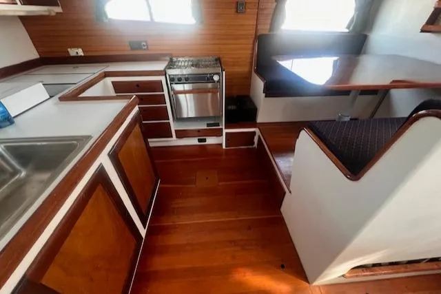 Miss Nina Yacht Photos Pics Interior of 1996 Custom Bolger PH Shoal-draft Ketch with kitchen and dining area.