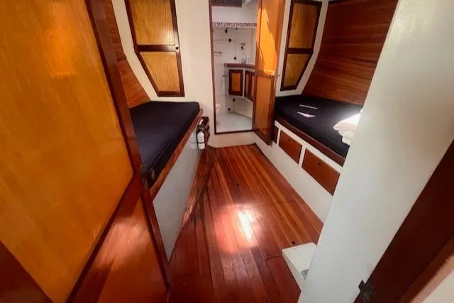 Miss Nina Yacht Photos Pics Interior of 1996 Custom Bolger PH Shoal-draft Ketch with wooden finishes and cozy sleeping area.