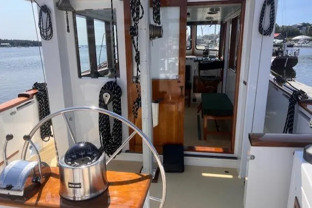 Miss Nina Yacht Photos Pics Interior view of a 1996 Custom Bolger PH Shoal-draft Ketch sailboat with steering wheel.