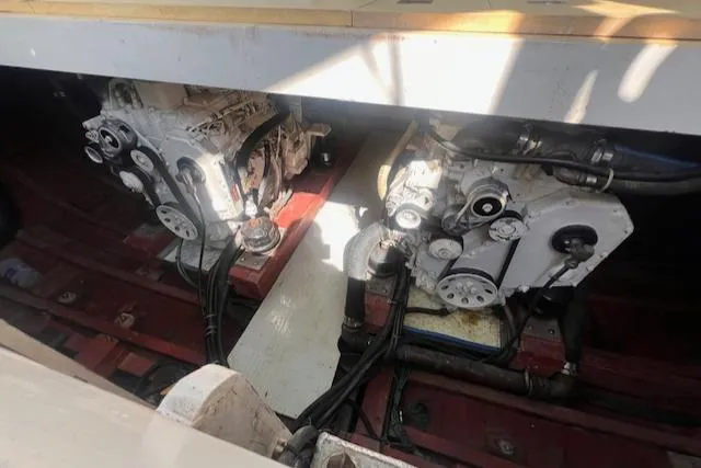 Miss Nina Yacht Photos Pics Engine room of 1996 Custom Bolger PH Shoal-draft Ketch, showcasing dual engines and mechanical components.