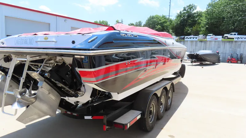  Yacht Photos Pics 2009 Donzi 35ZR speedboat on trailer, Lake Ozark, MO, with vibrant red and black design.