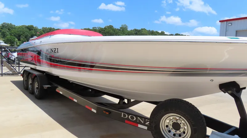  Yacht Photos Pics 2009 Donzi 35ZR speedboat on trailer, white with red accents, under clear blue sky.