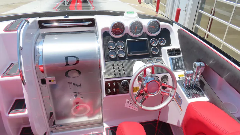  Yacht Photos Pics 2009 Donzi 35ZR boat cockpit with red seats, chrome steering wheel, and control panel.