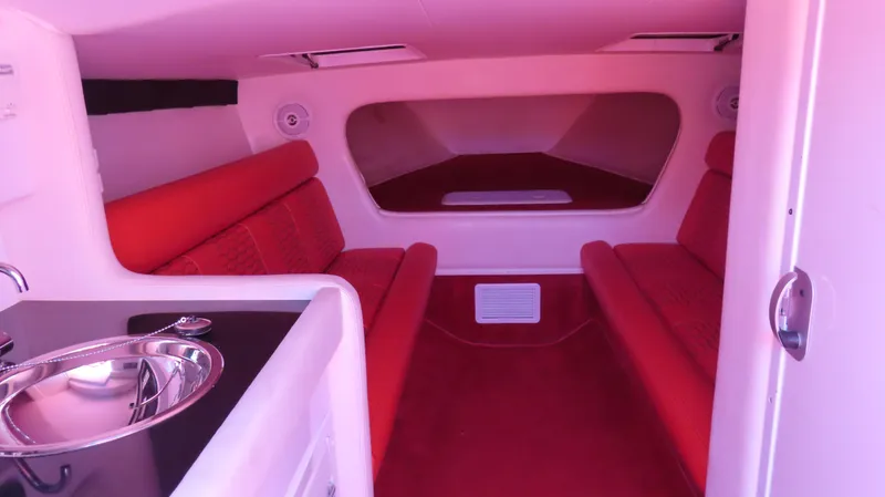  Yacht Photos Pics 2009 Donzi 35ZR cabin interior with red seating and compact kitchenette.