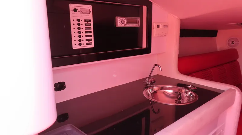 Yacht Photos Pics 2009 Donzi 35ZR interior with sink, control panel, and red seating.