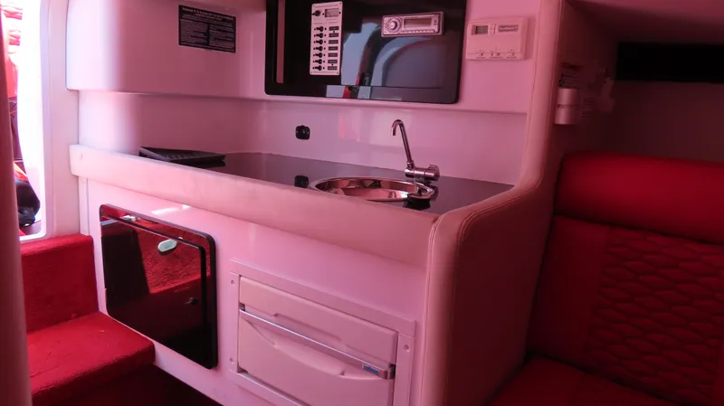  Yacht Photos Pics Interior of 2009 Donzi 35ZR boat with kitchenette and red seating.
