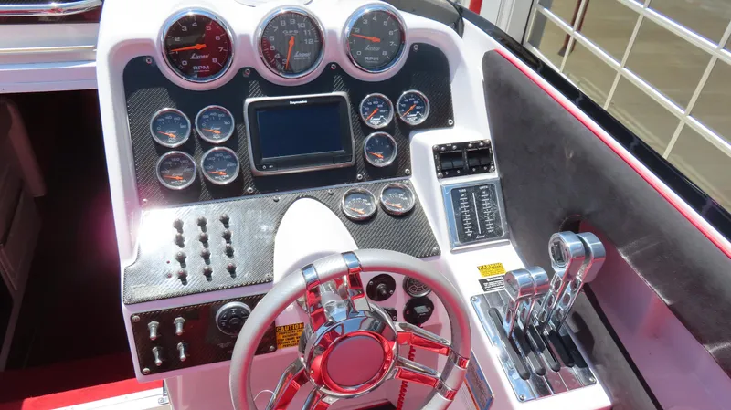  Yacht Photos Pics Dashboard of a 2009 Donzi 35ZR boat with gauges, steering wheel, and controls.