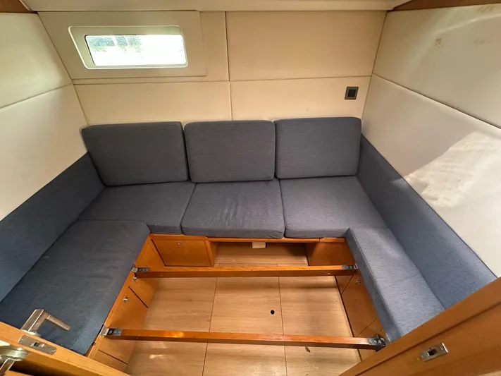 La Vieja Yacht Photos Pics Interior of 2011 Beneteau Sense 50 yacht with blue cushioned seating and wooden flooring.