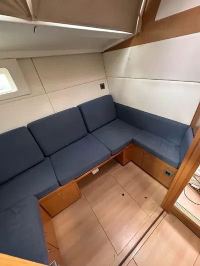 La Vieja Yacht Photos Pics Interior of 2011 Beneteau Sense 50 yacht with blue cushioned seating.