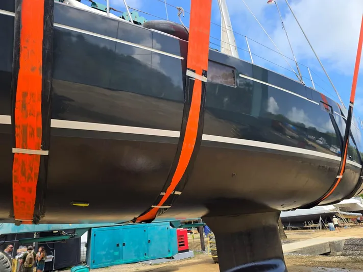 La Vieja Yacht Photos Pics 2011 Beneteau Sense 50 yacht in dry dock with orange straps, blue sky background.