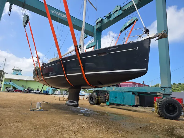 La Vieja Yacht Photos Pics 2011 Beneteau Sense 50 sailboat lifted by crane in a shipyard.