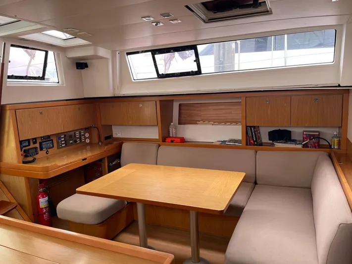 La Vieja Yacht Photos Pics Interior of 2011 Beneteau Sense 50 yacht with dining area and navigation station.