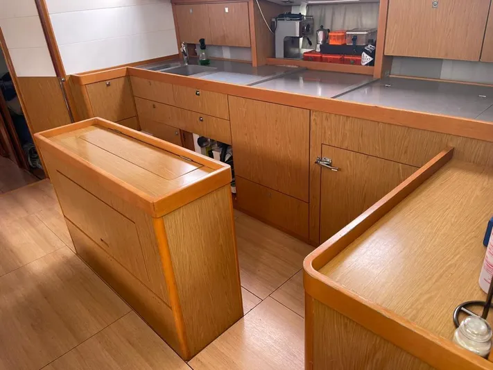La Vieja Yacht Photos Pics Spacious kitchen area in a 2011 Beneteau Sense 50 yacht with wooden cabinetry and modern design.