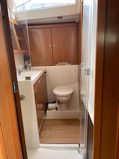 La Vieja Yacht Photos Pics Beneteau Sense 50 yacht bathroom, featuring wooden cabinetry and modern fixtures, 2011 model.