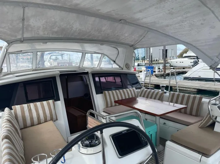 La Vieja Yacht Photos Pics Spacious cockpit of 2011 Beneteau Sense 50 yacht with striped seating and table.