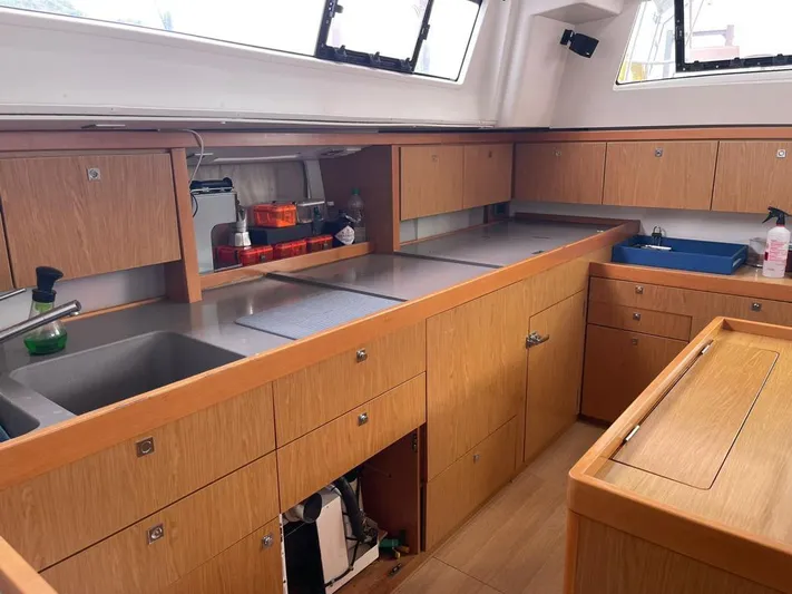 La Vieja Yacht Photos Pics Spacious kitchen interior of 2011 Beneteau Sense 50 yacht with wooden cabinetry and modern amenities.