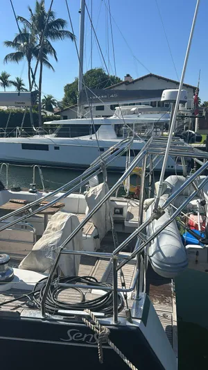 La Vieja Yacht Photos Pics 2011 Beneteau Sense 50 sailboat docked, with clear skies and palm trees in the background.
