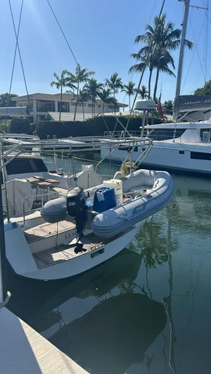 La Vieja Yacht Photos Pics Beneteau Sense 50 yacht, 2011 model, docked with inflatable boat, surrounded by palm trees.