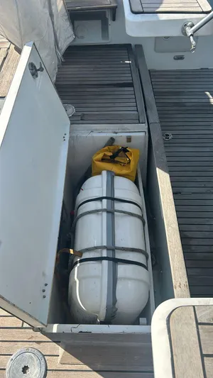 La Vieja Yacht Photos Pics Beneteau Sense 50 (2011) yacht storage compartment with life raft and yellow container.