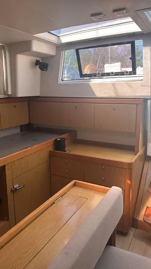 La Vieja Yacht Photos Pics Interior of 2011 Beneteau Sense 50 yacht with wooden cabinetry and large windows.