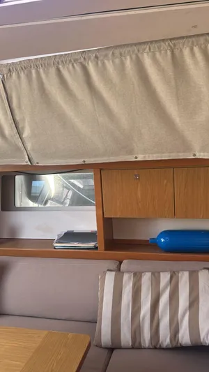 La Vieja Yacht Photos Pics Interior of a 2011 Beneteau Sense 50 yacht with wooden cabinetry and striped cushions.