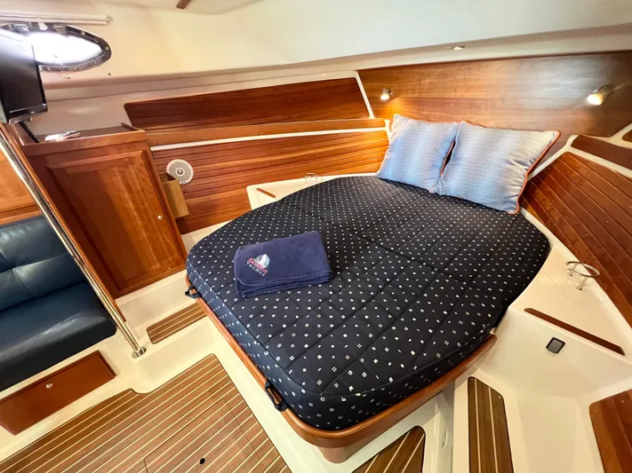 Traveller Yacht Photos Pics Luxurious cabin interior of 2016 Back Cove 34 yacht with cozy bed and wooden accents.