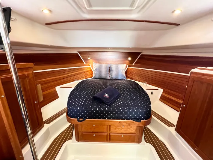 Traveller Yacht Photos Pics Luxurious cabin interior of 2016 Back Cove 34 yacht with cozy bedding and wooden accents.
